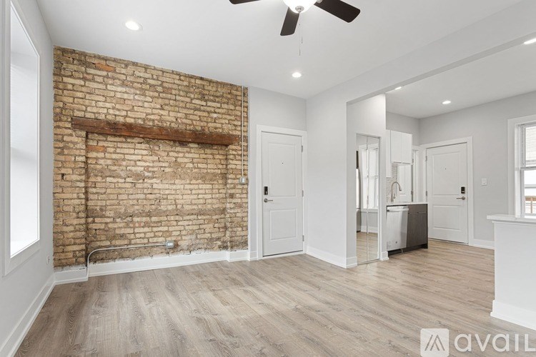 A room with a brick wall and wooden flooring.