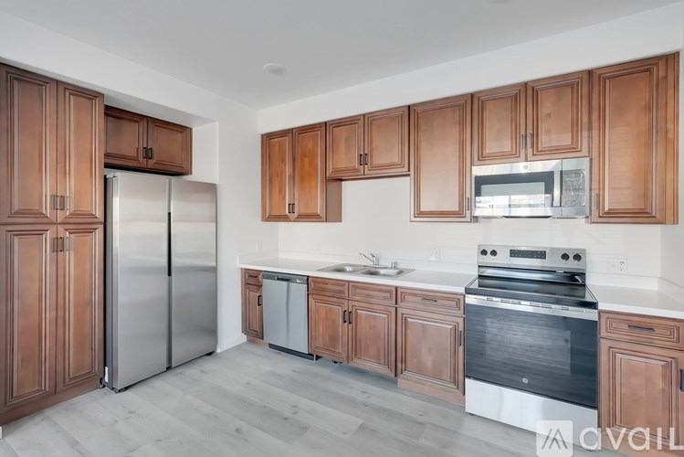A kitchen with wooden cabinets and stainless steel appliances.