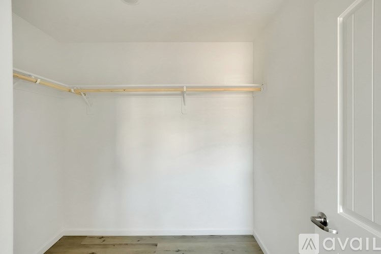 A white room with a door and a white wall.