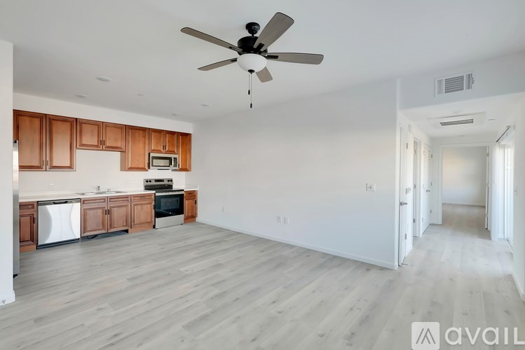 A spacious kitchen with wooden cabinets and a white refrigerator.