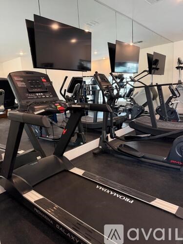 A treadmill with a screen on top of it.