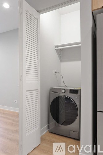 A washing machine is in a small room.
