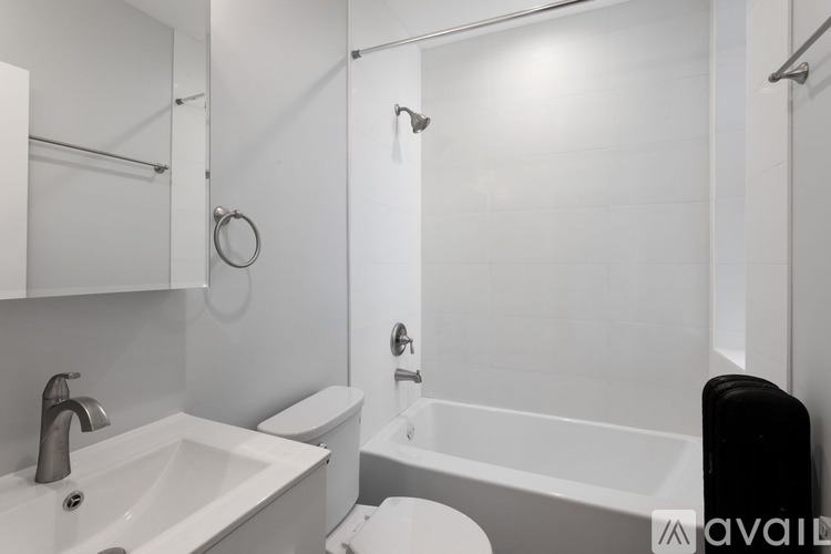A white bathroom with a sink, toilet, and bathtub.