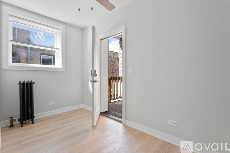A room with a window and a radiator on the floor.
