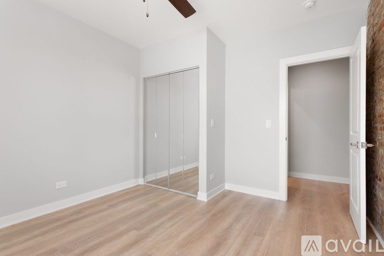 A room with a glass door and a ceiling fan.