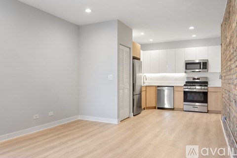 A kitchen with a refrigerator, microwave, oven, and dishwasher.
