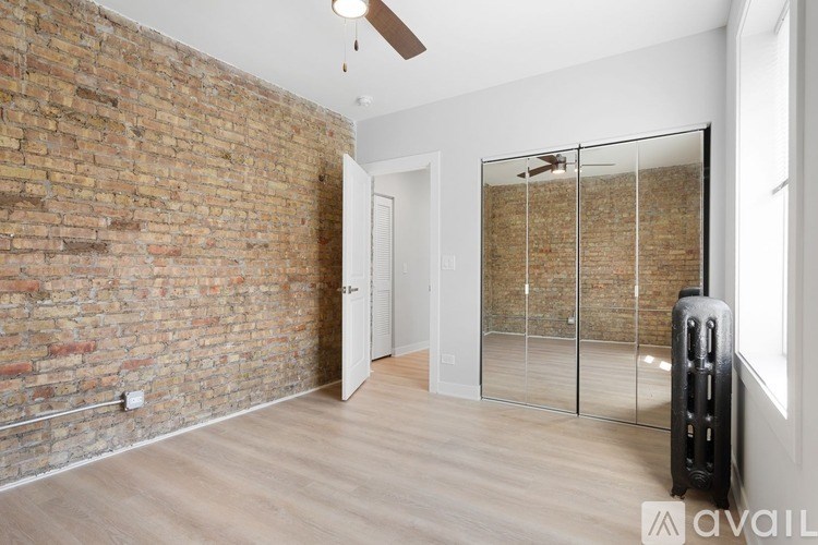A room with a brick wall and a glass door.