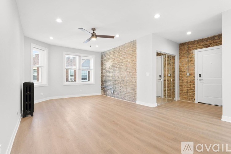A room with a brick wall and wooden flooring.