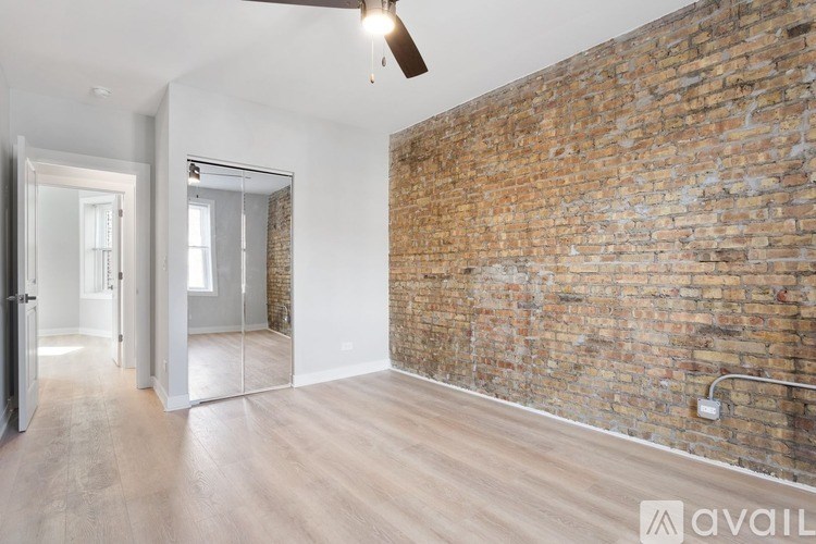 A room with a brick wall and wooden flooring.