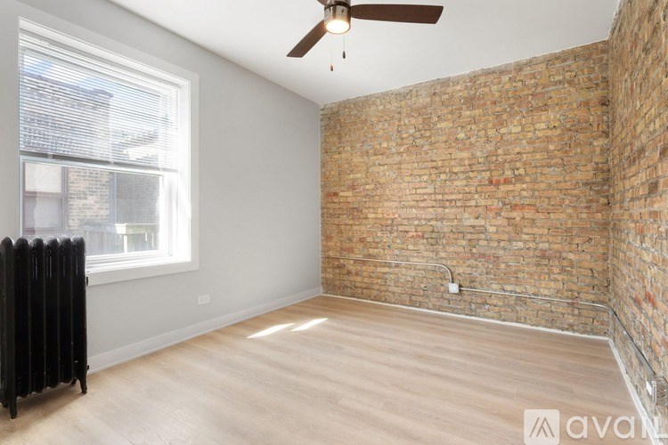 A room with a brick wall and wooden floor.
