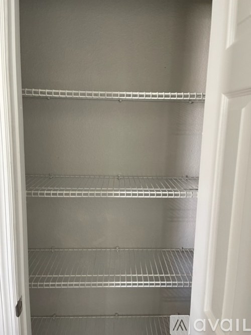 Empty shelves in a white refrigerator.