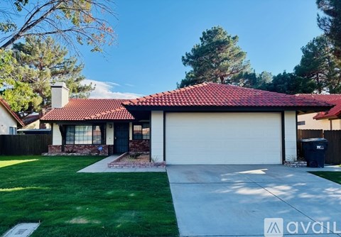 A house with a red tiled roof and a white garage door.