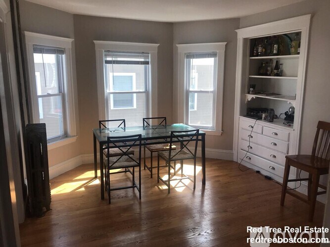 A dining room with a glass table and chairs.