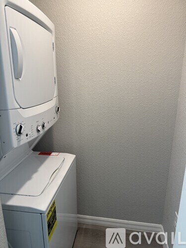 A white washing machine and dryer in a small room.