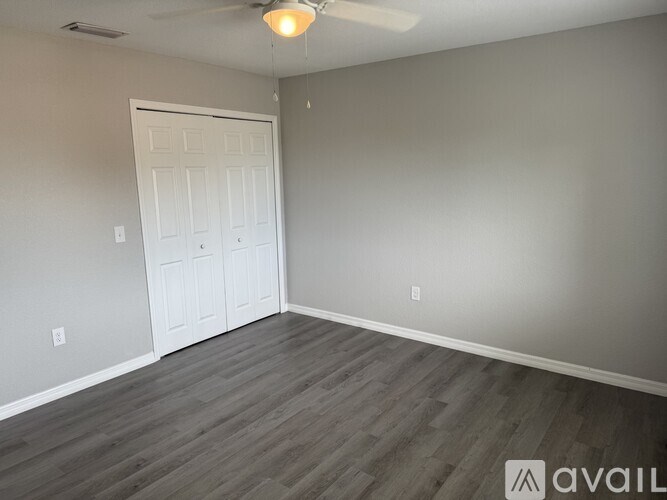 A room with a white door and grey walls.