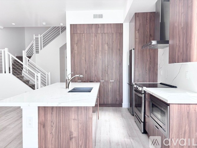 A modern kitchen with wooden cabinets and stainless steel appliances.