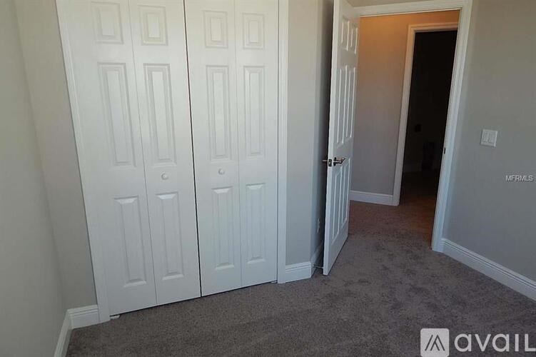 A room with three white doors and a carpeted floor.