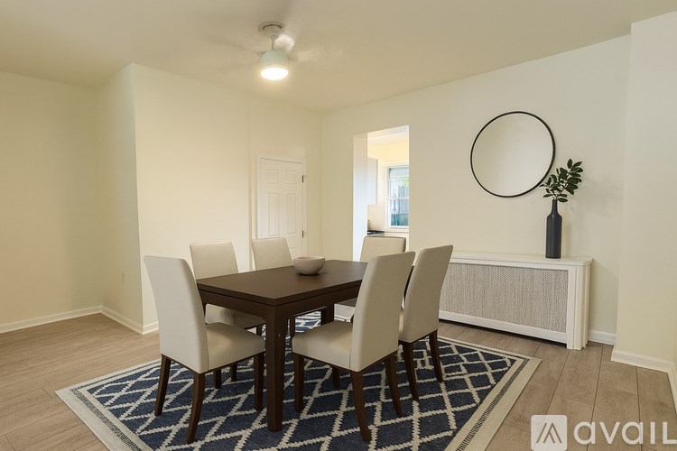 A dining room with a table and chairs.