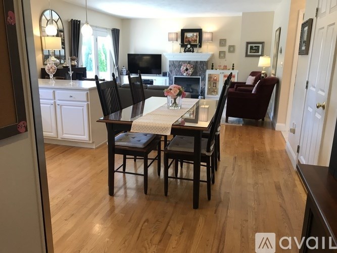A dining room with a table and chairs.