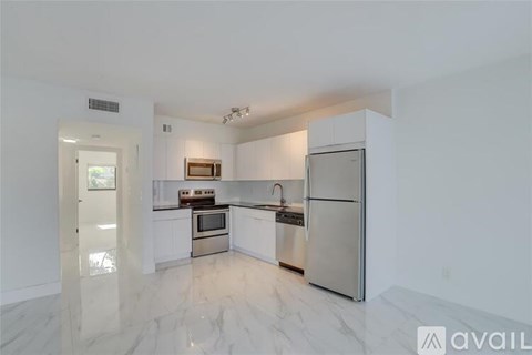 A kitchen with white cabinets and stainless steel appliances.