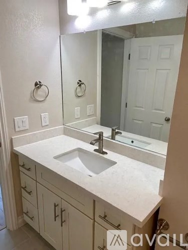 A bathroom with a sink and mirror.