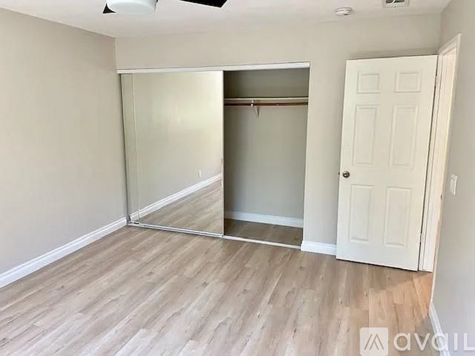 A room with a sliding door and a white door.