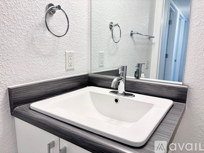 A white sink with a silver faucet is on a counter.