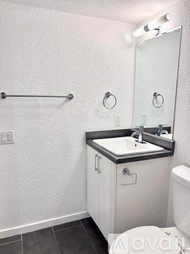 A bathroom with a white sink and toilet.