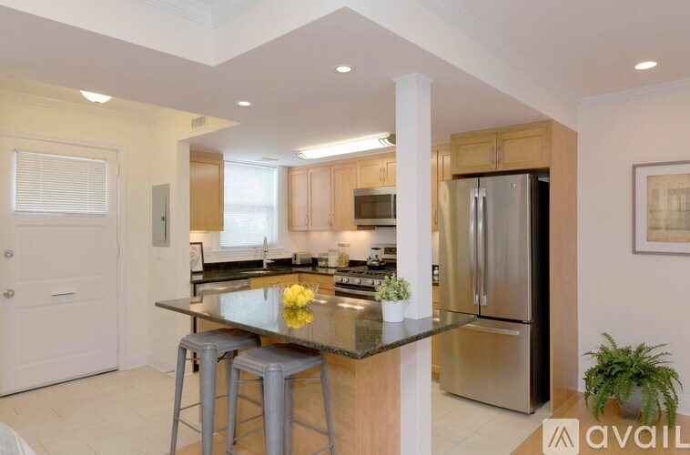 A kitchen with a granite countertop and stainless steel appliances.