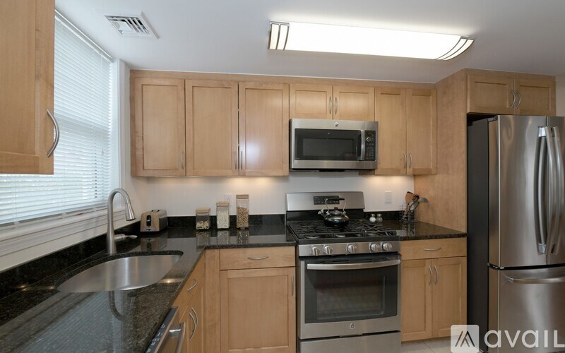 A kitchen with wooden cabinets and stainless steel appliances.