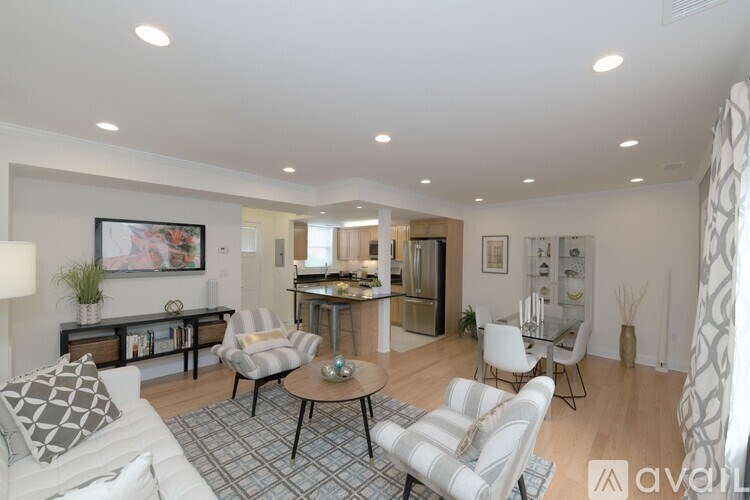 A living room with a white couch and a coffee table.