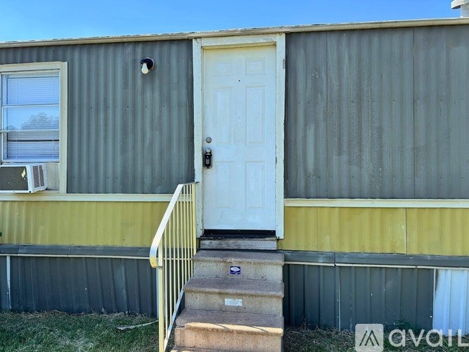 A house with a white door and a yellow window.