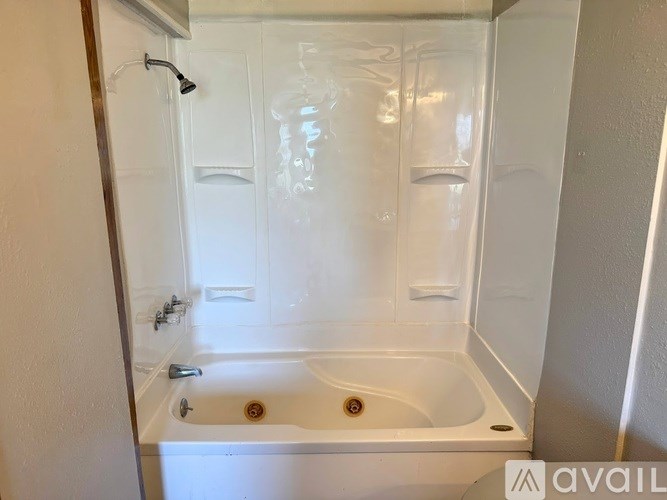 A white bathroom with a bathtub and shower.