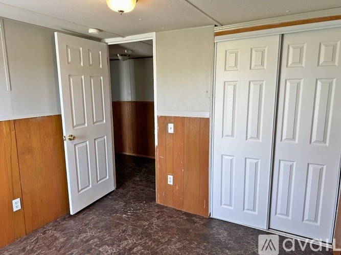 A room with two doors, one white and one brown.