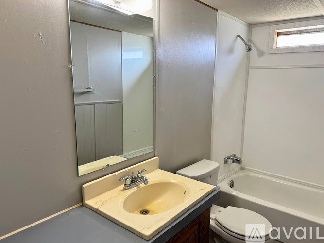 A bathroom with a sink, toilet, and bathtub.