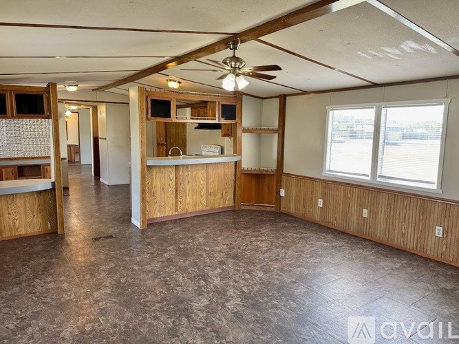 A room with wooden walls and a ceiling fan.