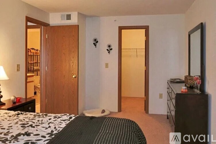 A bedroom with a bed, dresser, and mirror.
