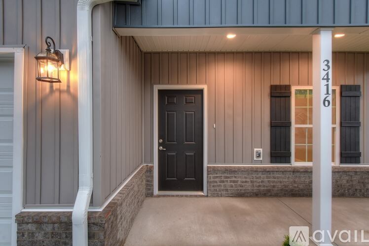 A house numbered 3416 is shown with a black door and a lamp on the wall.