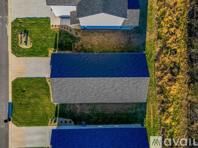 A bird's eye view of a residential area with houses and a small garden.