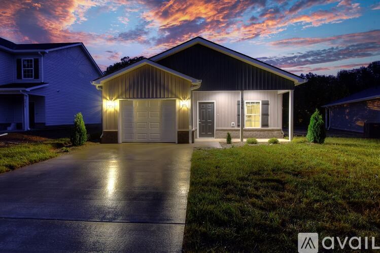 A house with a driveway and garage is available for sale.