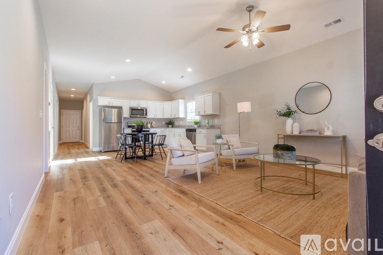 A spacious living room with a dining table and chairs.