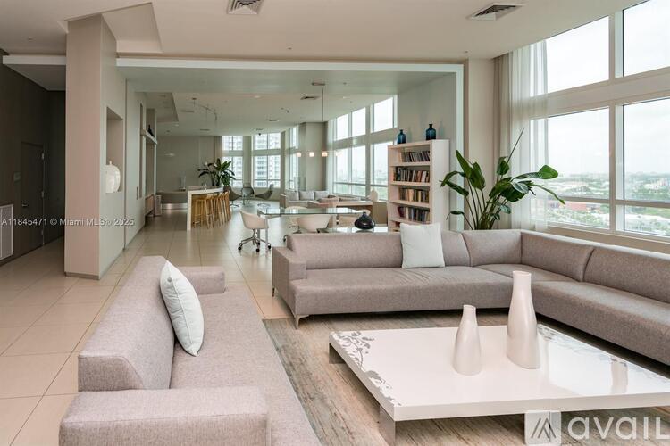 A modern living room with a large sofa set and a coffee table.