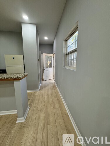 A kitchen with a counter top and a fridge.