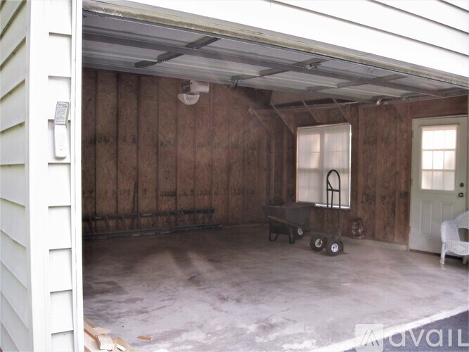 A room with wooden walls and a white chair is available.