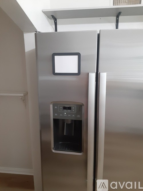 A stainless steel refrigerator with a water dispenser on the door.