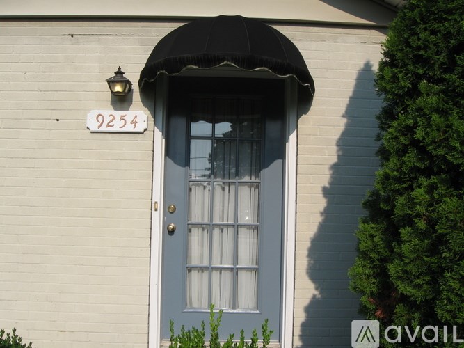 A house with the number 9254 on the wall above the door.