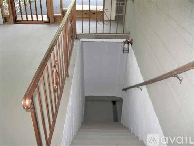 A room with a wooden floor and a white cabinet.