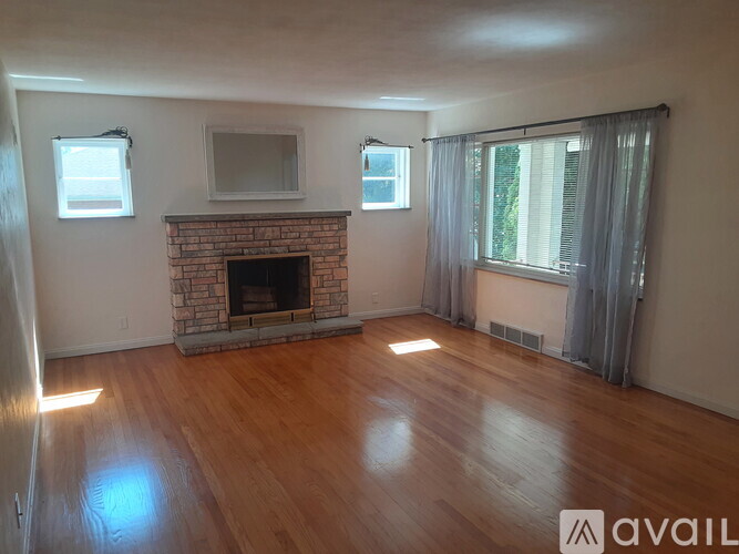 A living room with a fireplace and a television.