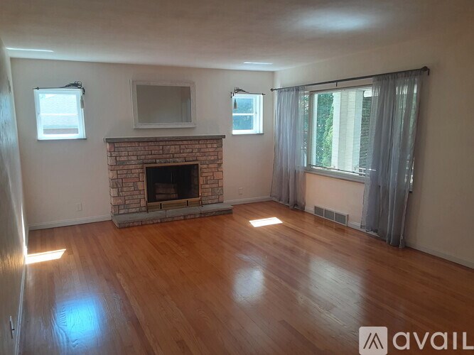 A living room with a fireplace and a television.