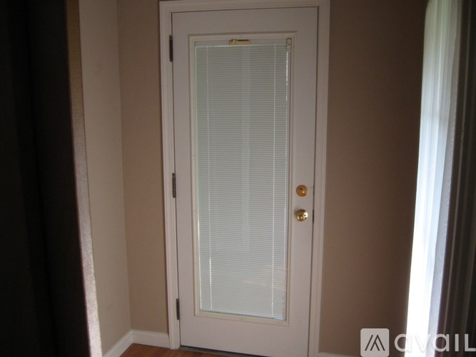 A white door with a glass panel and a handle.